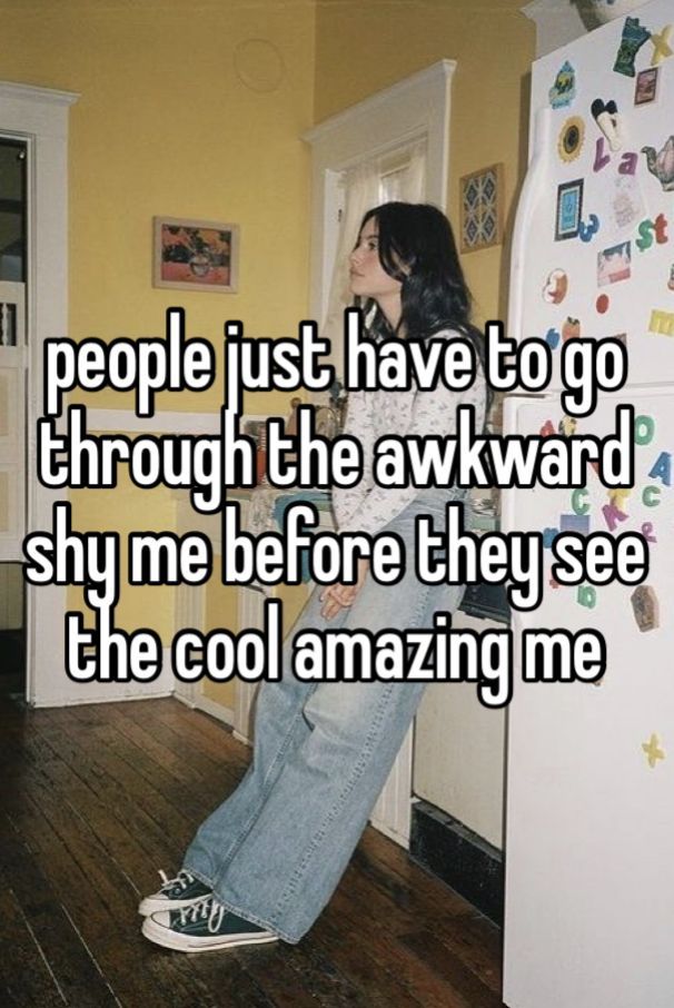 a woman sitting on the floor next to a refrigerator