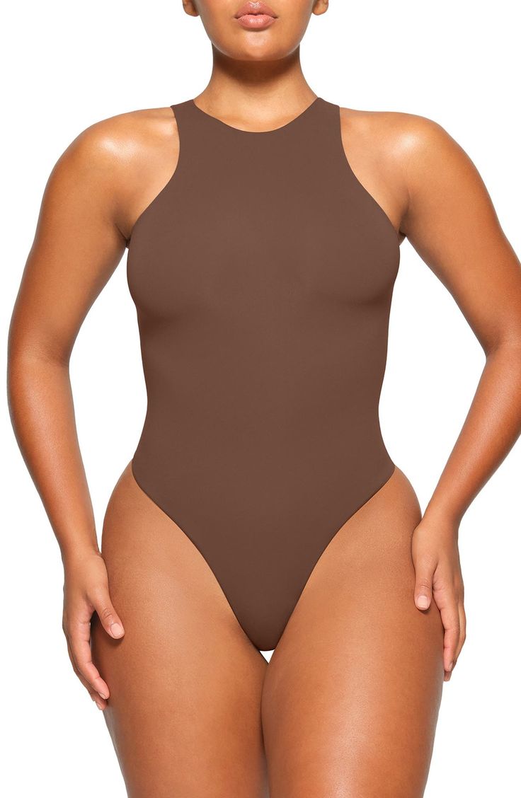 Sculpt your body's natural shape with a high-neck bodysuit from Kim Kardashian's SKIMS that holds you in and lifts you up in all the right places. Reflecting the brand's passion for highly technical shapewear solutions for every body, this everyday piece has whisper-soft, seamless construction, high-cut legs and a thong back that remains invisible under clothing. Snaps between legs Crewneck Sleeveless Lined 76% polyamide, 24% elastane Machine wash, tumble dry Imported High Neck Bodysuit, Natural Shapes, Black Fits, High Cut, Kim Kardashian, Shapewear, Everyday Fashion, Fashion Blog, High Neck