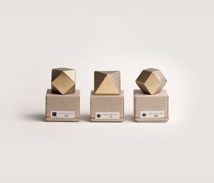 three gold cubes sitting on top of each other in front of a white background