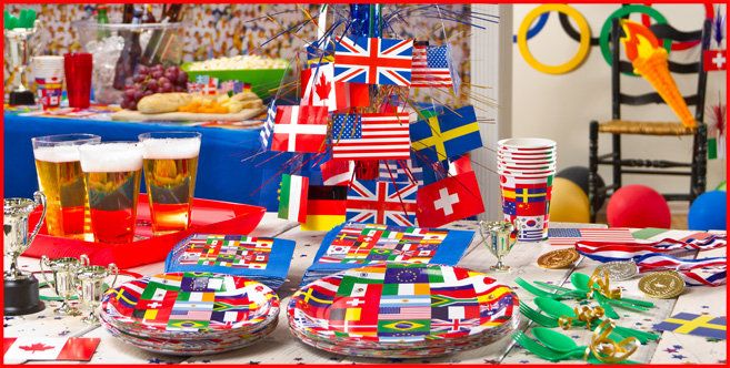 a table topped with plates and cups filled with food next to flags on top of each plate