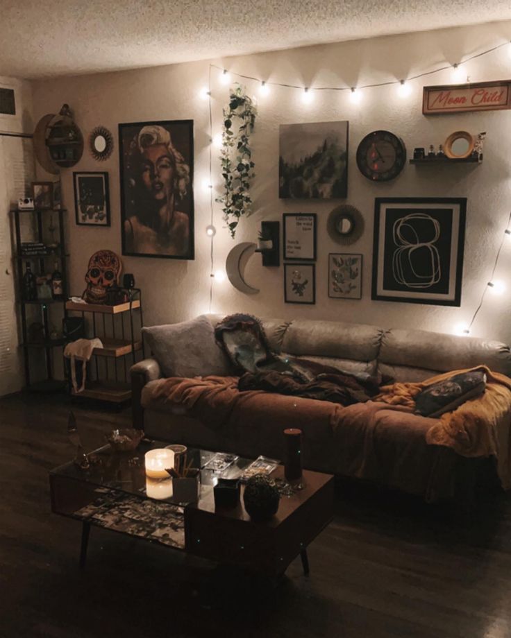 a living room filled with furniture covered in pictures and string lights on the wall above