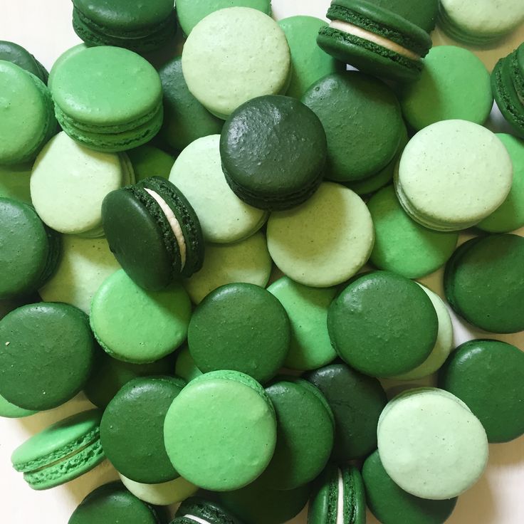 green and white macaroons are scattered together