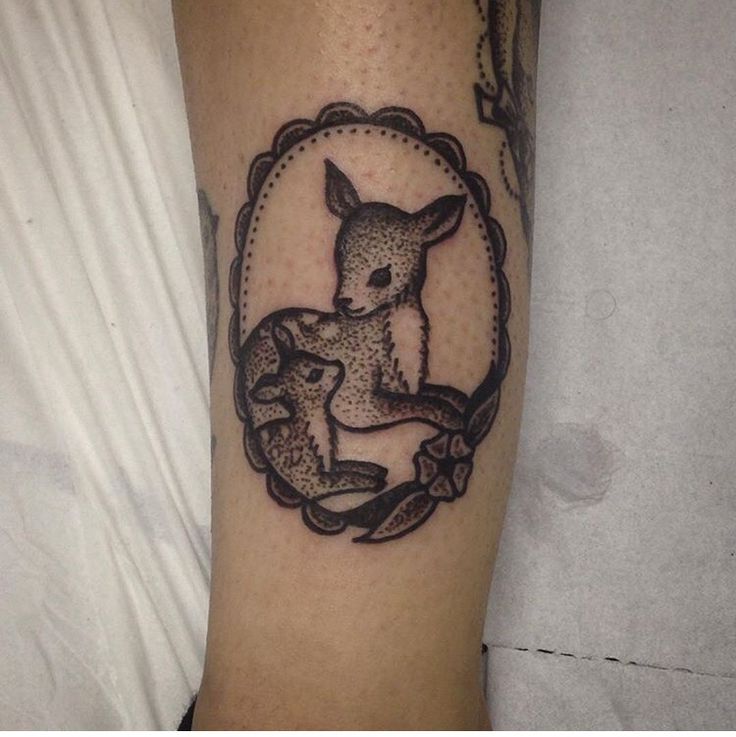 a tattoo on the leg of a person with a rabbit in it's frame