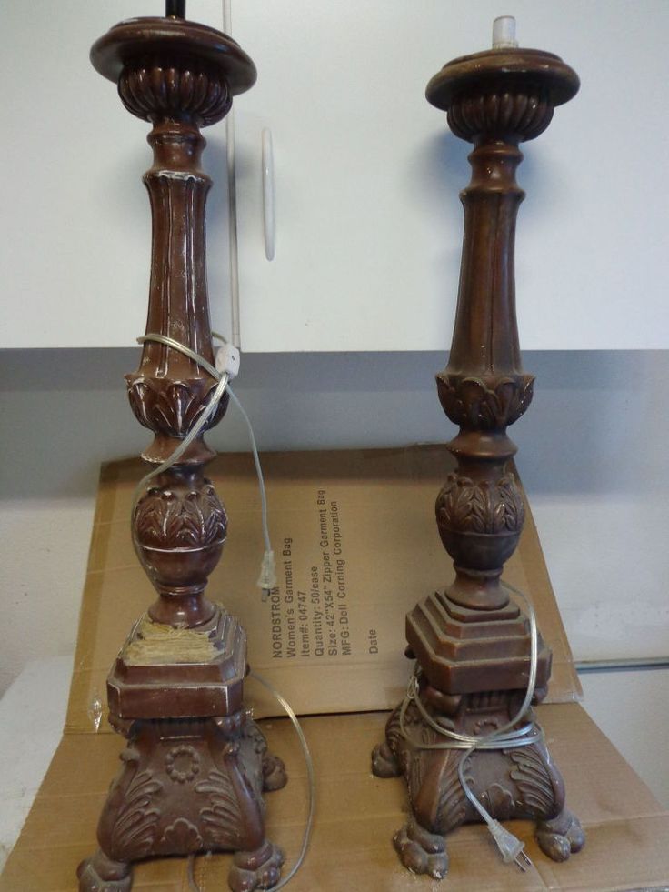 two wooden candlesticks sitting next to each other on top of a cardboard box