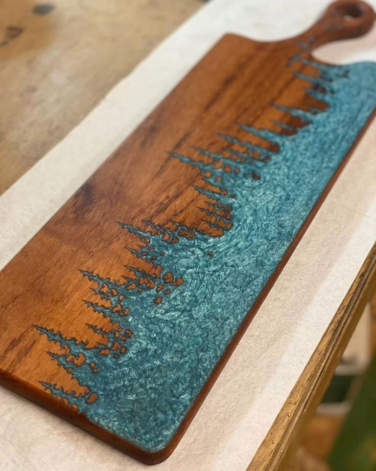 a wooden cutting board sitting on top of a table