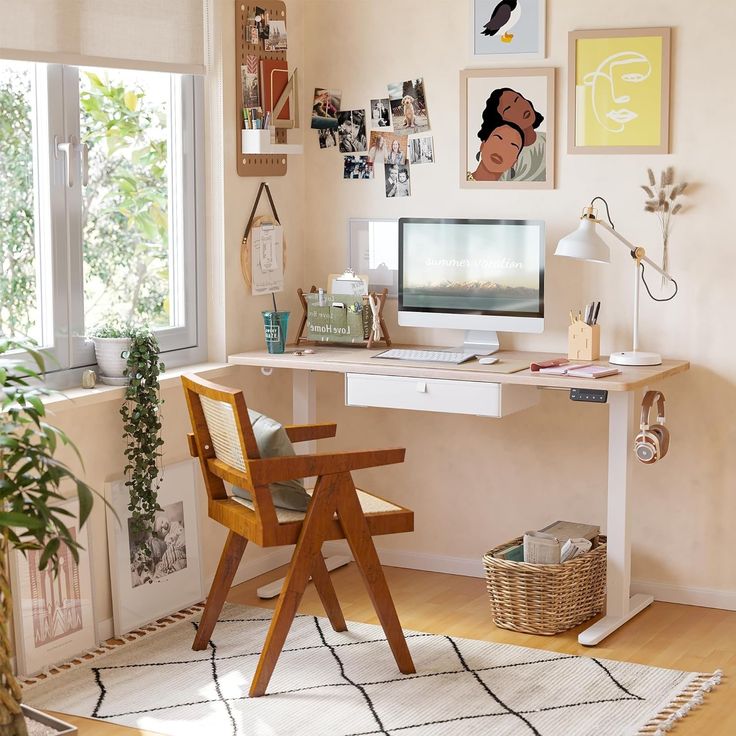 a desk with a computer on top of it in front of a window filled with pictures