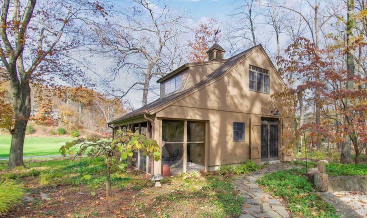 a small house in the woods surrounded by trees