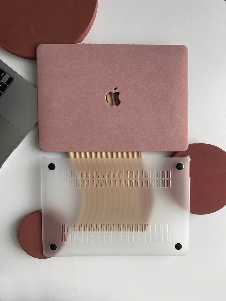 an apple laptop computer sitting on top of a white table next to a macbook pro