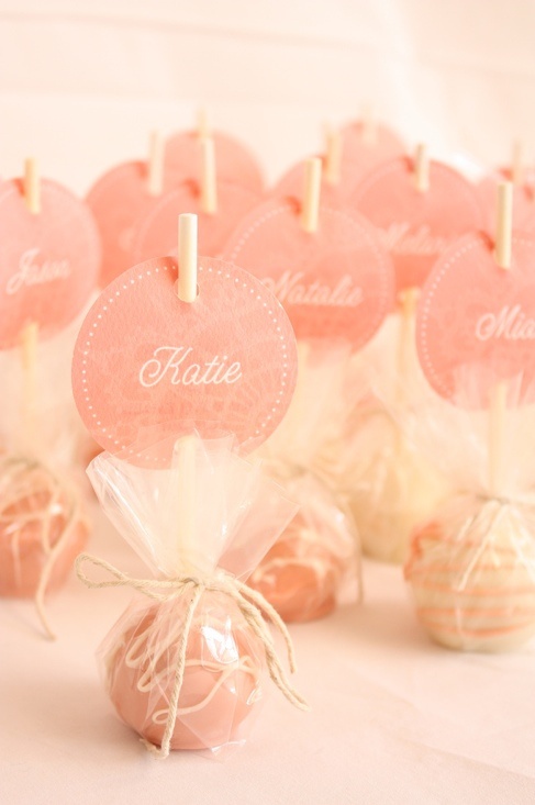 some candy lollipops are wrapped in cellophane and tied with twine