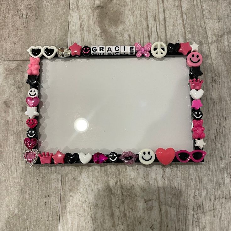 a mirror with hearts, peace signs and other decorations on it that says grace in the middle