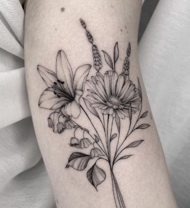 a black and white photo of flowers on the arm, with one flower in it's center