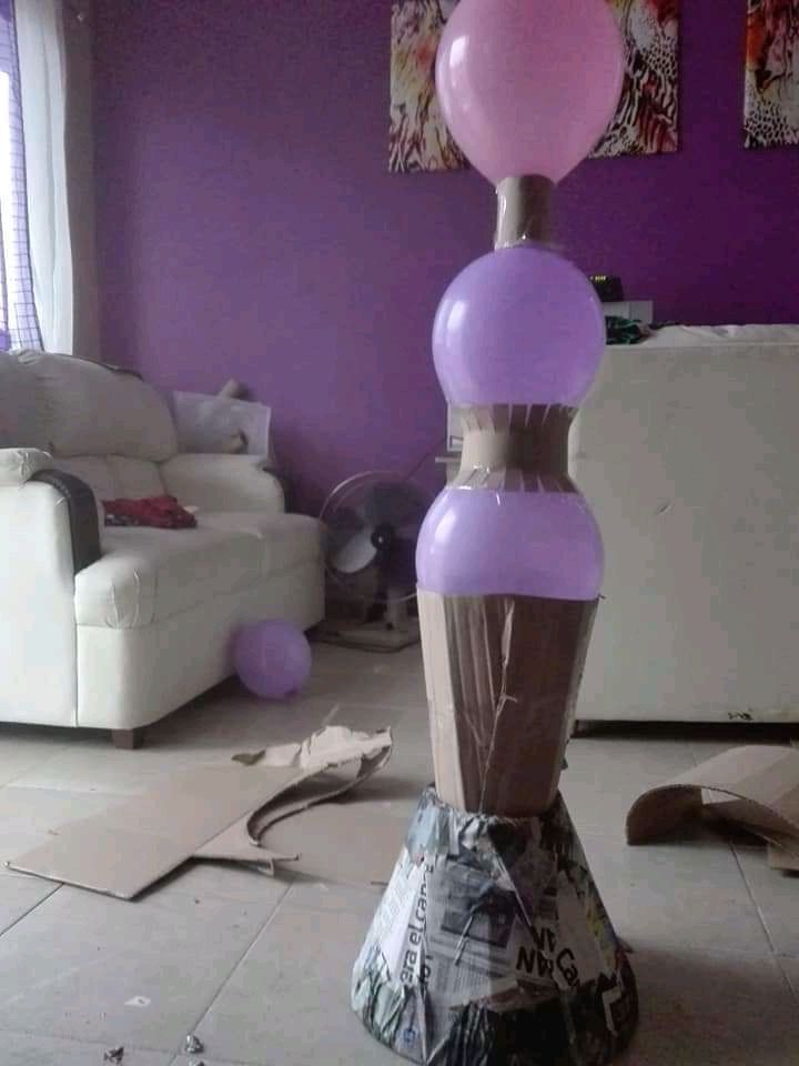 there are balloons on top of the cupcakes in this living room, and it looks like they have been blown off