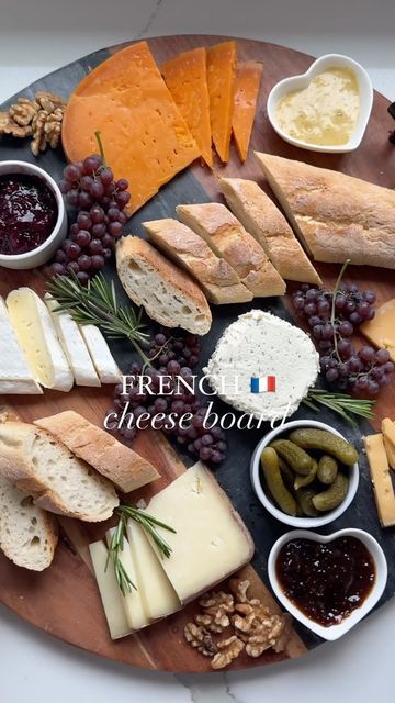 an assortment of cheeses and crackers on a wooden platter