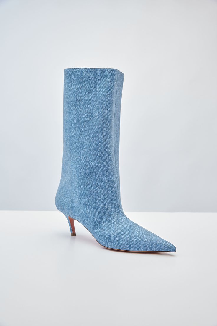 For Spring/Summer 2024, Amina Muaddi played with the idea of trompe l'œil by crafting a pair of thigh-high suede boots with a denim print. Spring Denim Knee-high Boots, Spring Knee-high Denim Boots, Denim Knee-high Boots For Spring, Denim Summer Boots, Fitted Denim Summer Boots, Fitted Denim Boots For Summer, Trendy Fitted Denim Blue Boots, Fitted Denim Blue Boots For Fall, Chic Denim Blue Boots For Fall