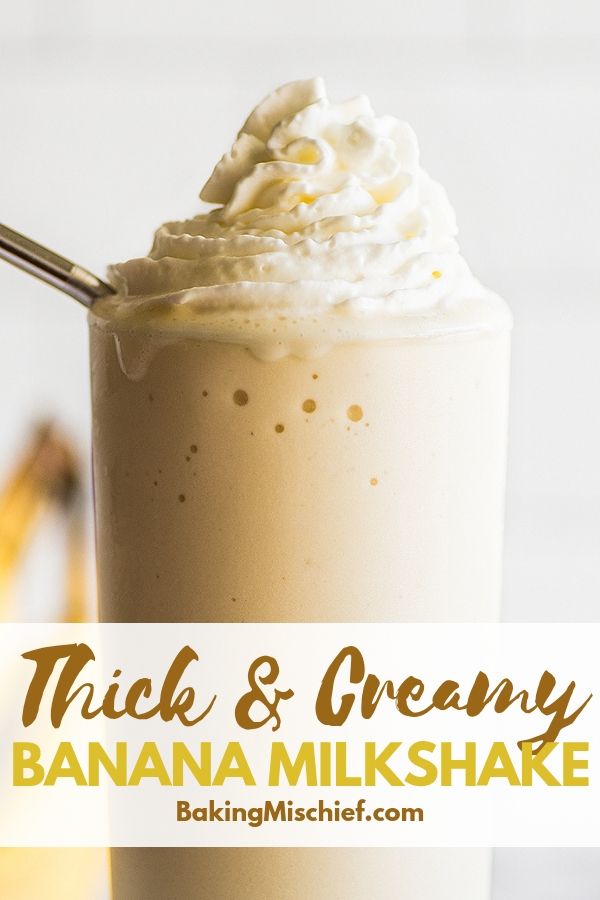 thick and creamy banana milkshake in a tall glass with whipped cream on top