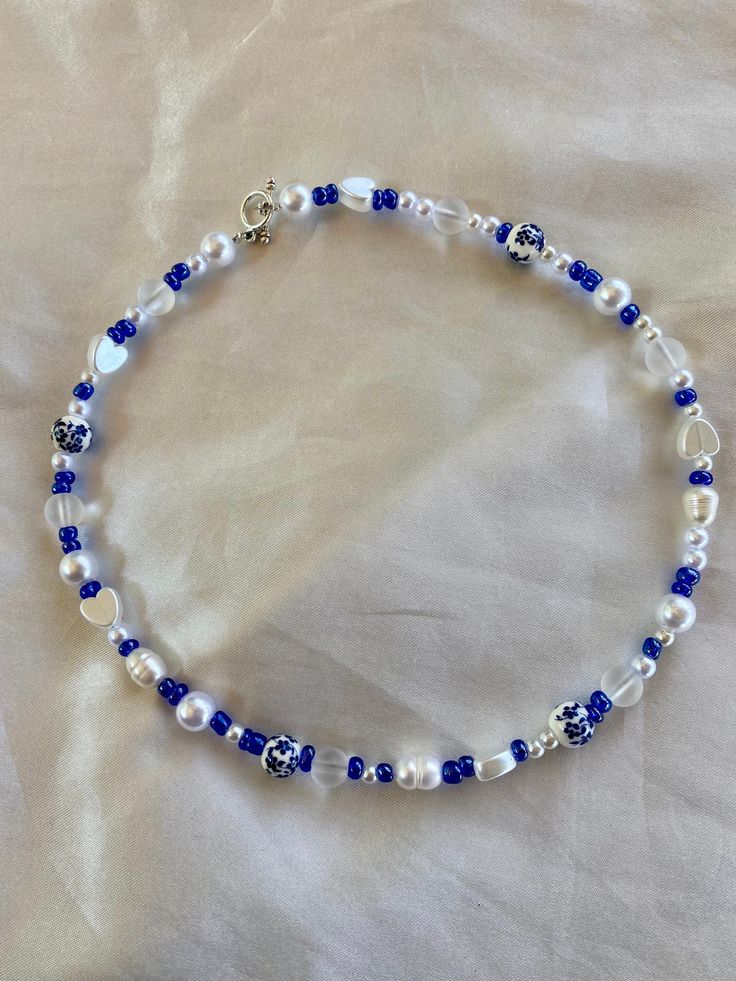 This beautiful blue beaded necklace is made with a variety of different types beads! No specific pattern so each necklace is different! This necklace is 15 inches long! Happy shopping Blue Beaded Necklaces With Oval Beads, Blue Oval Beaded Necklaces, Blue Oval Beads Necklace With Beaded Chain, Blue Oval Beads Necklaces For Jewelry Making, Blue Beaded Chain Necklace With Oval Beads, Blue Oval Beaded Chain Necklaces, Blue Bohemian Pearl Necklace For Gift, Blue Necklace With Oval Beads, Handmade Blue Beaded Necklaces With Oval Beads