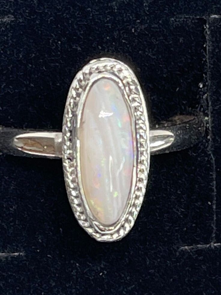 Stunning Opal ring size 9 in .999 fine silver and .925 sterling silver. October birthstone Classic Sterling Silver Jewelry With Stone Setting, Elegant Silver Opal Stackable Rings, Adjustable White Opal Ring In Sterling Silver, Oval Sterling Silver Stackable Rings With Polished Finish, Oval Stackable Rings In White Gold And Sterling Silver, Adjustable Nickel-free Silver Opal Ring, Sterling Silver Spiritual Opal Ring, White Gold Moonstone Ring Stamped 925, Sterling Silver Engraved Gemstone Ring