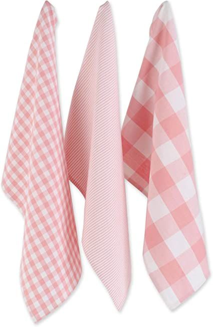 three pink and white checkered ties hanging from the side of each other on a wall