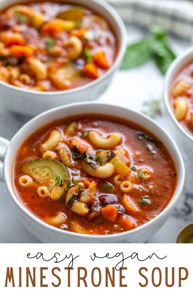 three white bowls filled with minestone soup on top of a marble counter and the words easy vegan minestone soup above it