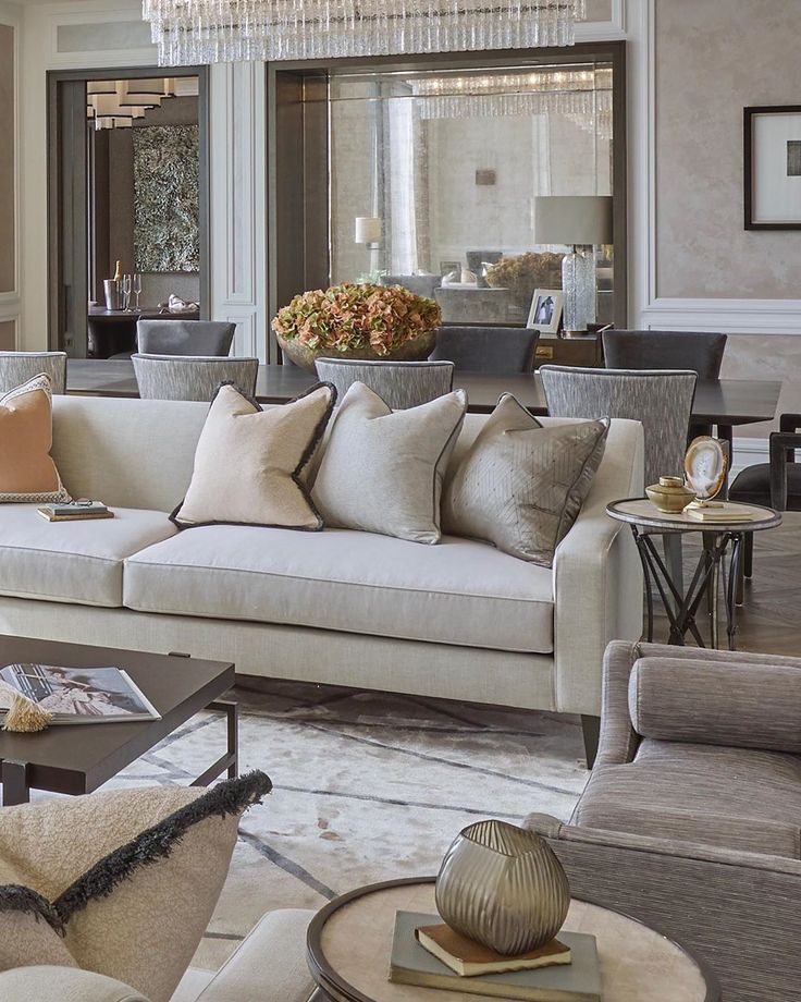 a living room filled with furniture and a chandelier