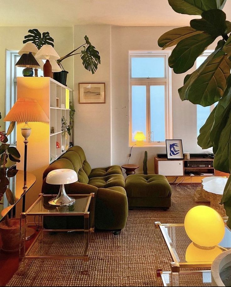 a living room filled with lots of furniture and plants on top of it's walls