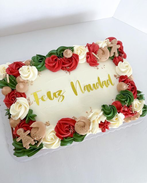 a white cake with red and green flowers on it's side that says taz nanad