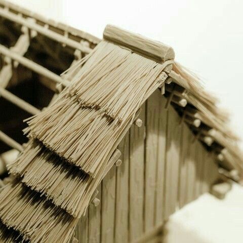 the roof of a hut made out of straw and wood planks is shown in sepia