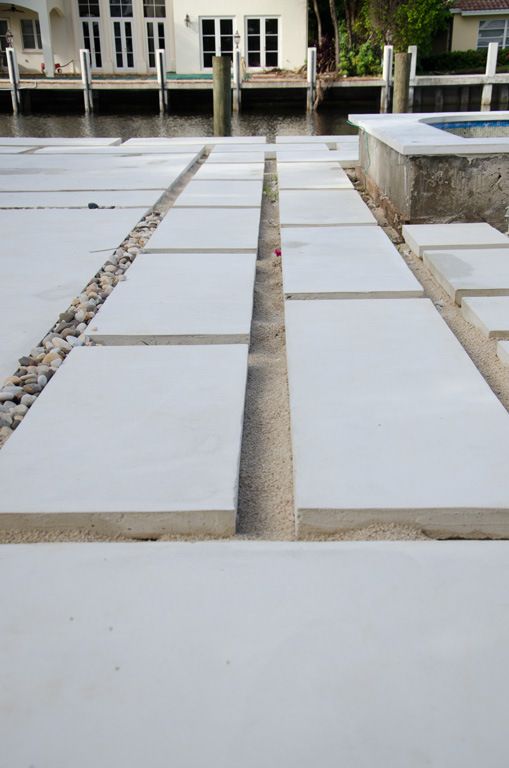 cement blocks laid out on the ground in front of a house