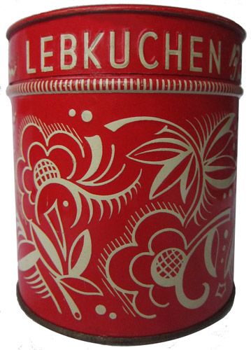 a red tin with white designs on it