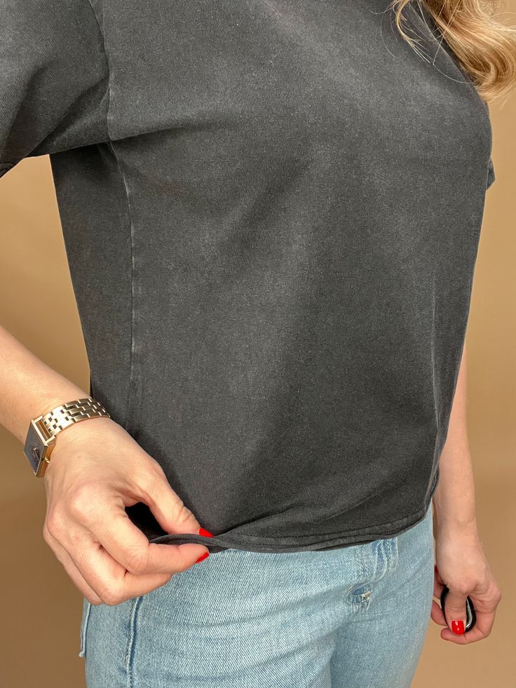 This black mineral washed tee features a slight crop and a raw bottom hem, creating an effortless look that hits at the top of the hips. Perfectly paired with denim for a stylish and comfortable outfit. Details: Slightly cropped fit Raw bottom hem Fit: true to size, Amber is modeling size Small. Contents: 100% Cotton Imported. Acid Wash Relaxed Fit Cropped Tops, Acid Wash Cropped Top Relaxed Fit, Relaxed Fit Soft-washed Medium Wash Tops, Black Distressed T-shirt For Everyday, Black Distressed T-shirt, Acid Wash T-shirt With Frayed Hem And Relaxed Fit, Trendy Acid Wash Cropped Tops, Washed Cropped Cotton Tops, Everyday Distressed Black Tops