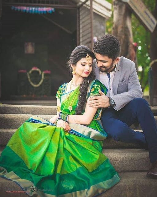 a man sitting next to a woman in a green sari on the steps with her arms around her chest