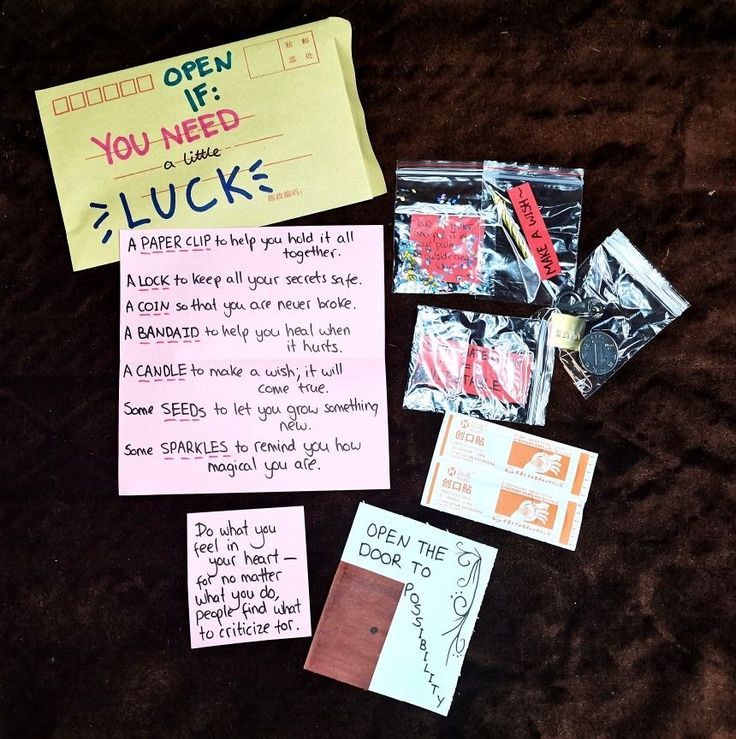 a pile of random items that include candy and notes to someone who wants to open if you need luck