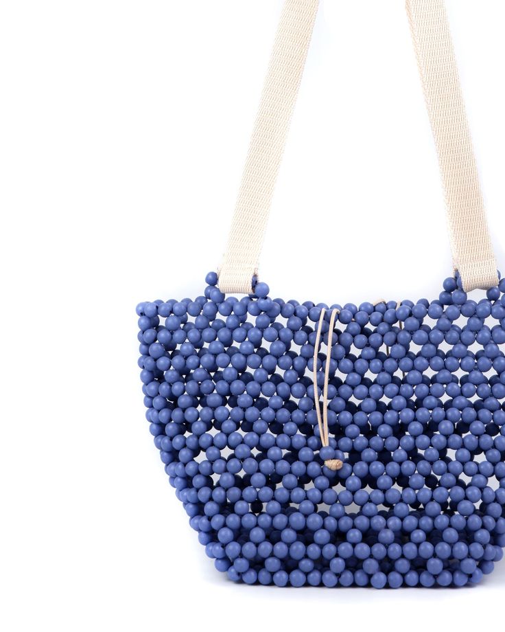 This is probably the bag you didn't know you needed—our take on the undeniably reliable tote bag. Imagine beachside or on the go in the city, the Riki basket bag will carry everything you need. Composition: Handmade Wood beads Bead slide closure Canvas straps Dimensions: 31cm x 15cm x 18cm (LxWxH) Blue Handwoven Bucket Bag, Blue Handwoven Summer Shoulder Bag, Summer Blue Handwoven Shoulder Bag, Blue Woven Bags For Beach Season, Blue Handwoven Summer Bags, Handwoven Blue Summer Bag, Summer Blue Handwoven Bags, Casual Blue Bucket Bag With Braided Handles, Blue Bucket Beach Bag With Adjustable Strap