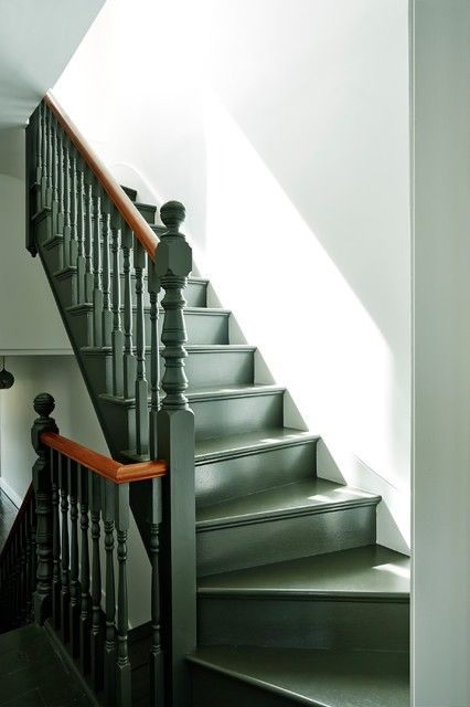 a stair case next to a white wall