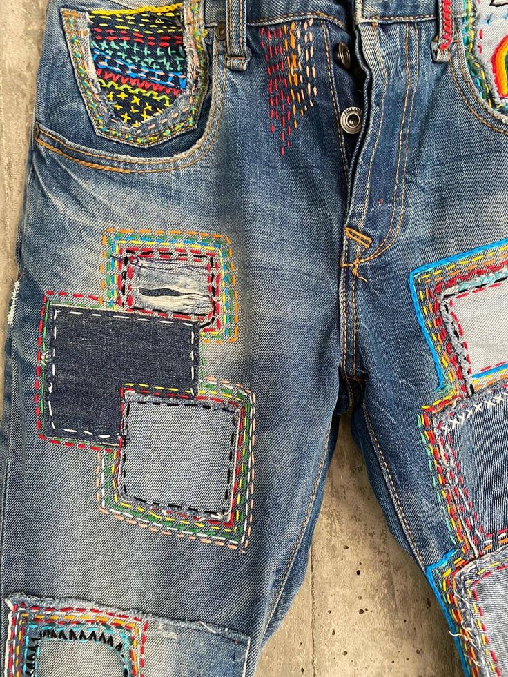 a pair of jeans with colorful patches on them