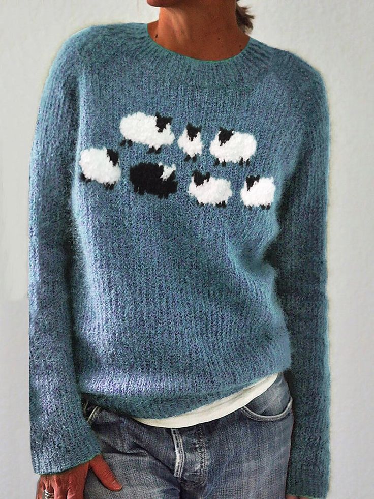 a woman wearing a sweater with sheep on it