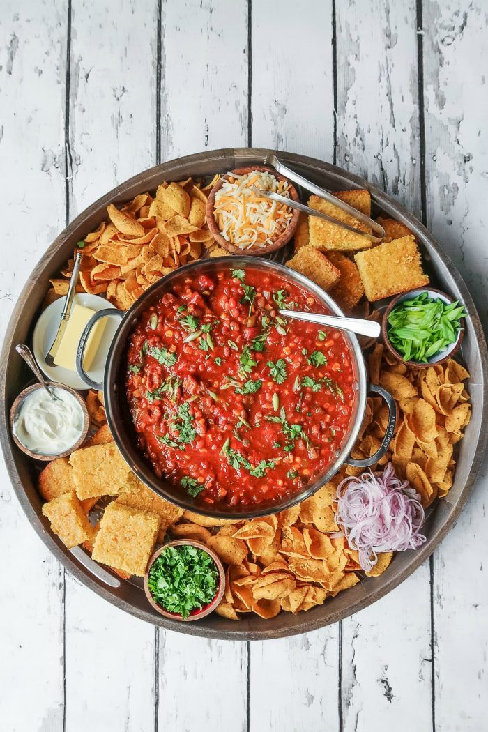 a platter filled with chips, salsa and guacamole