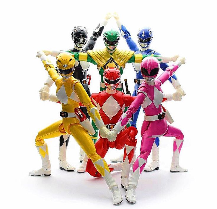 five different colored power ranger action figures standing in a circle with their hands up to the sides