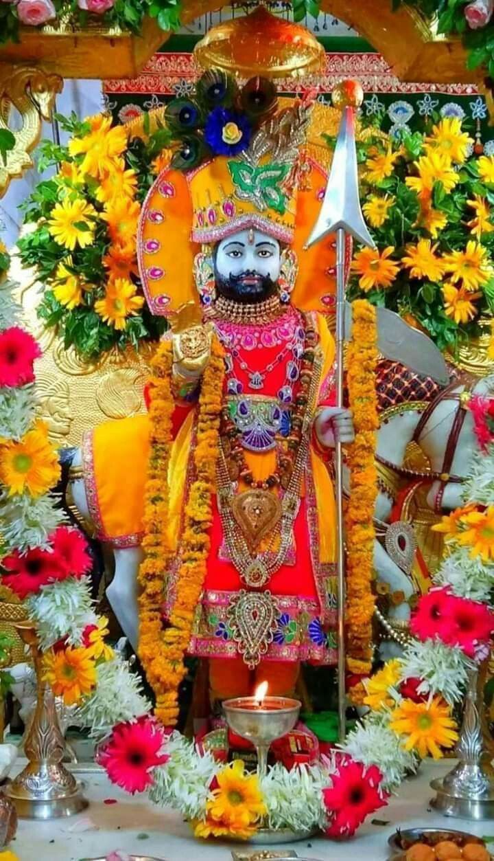 the idol is surrounded by flowers and garlands