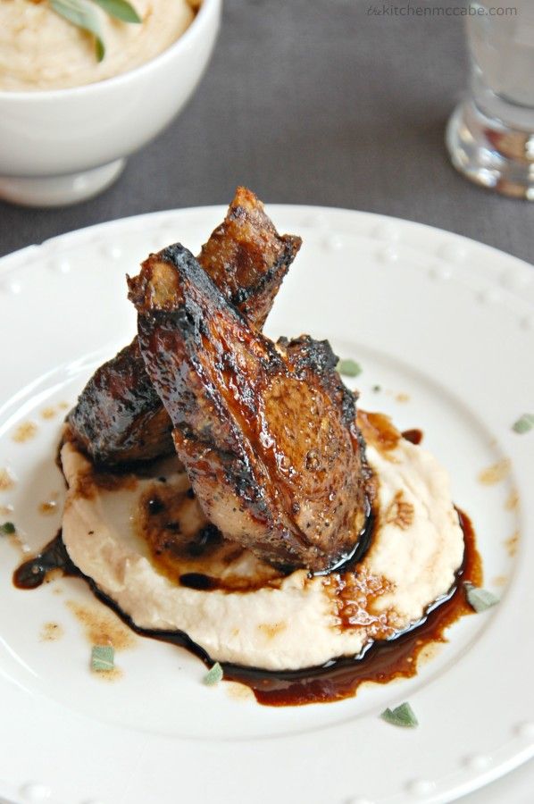 a plate with some meat on top of mashed potatoes