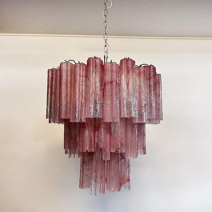 a pink chandelier hanging from a ceiling