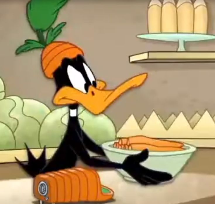 a cartoon duck with a carrot in it's mouth sitting on the floor next to a bowl