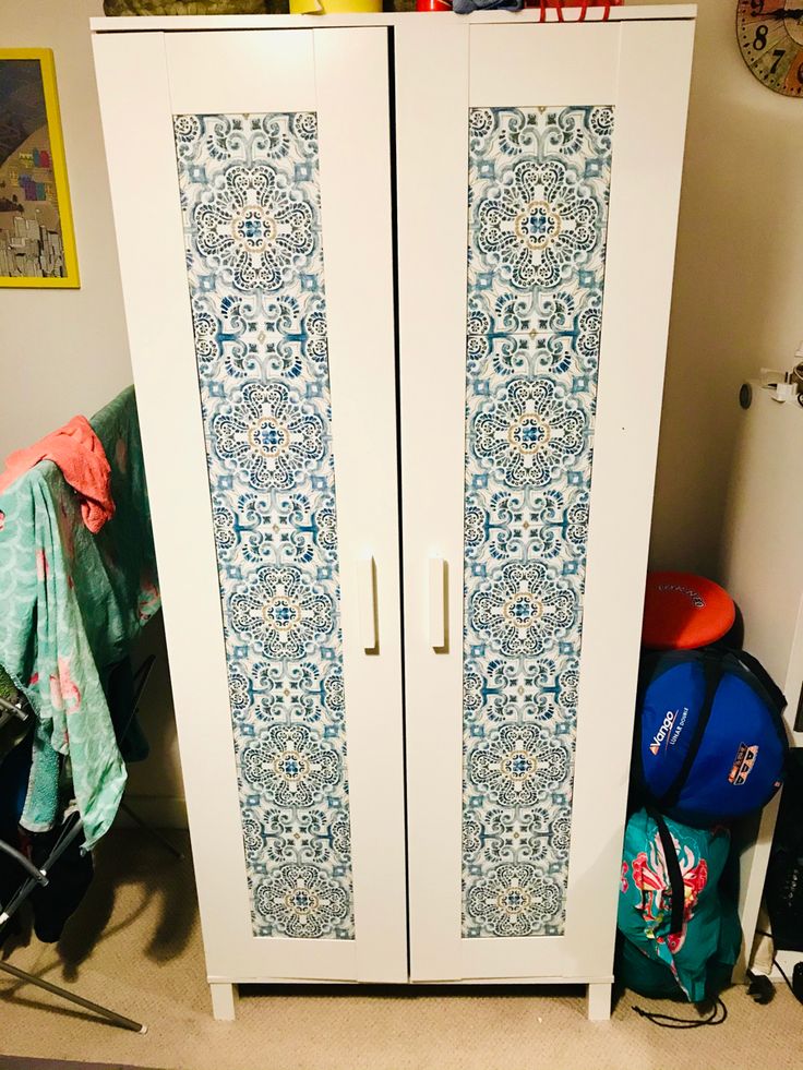 an armoire with blue and white designs on it