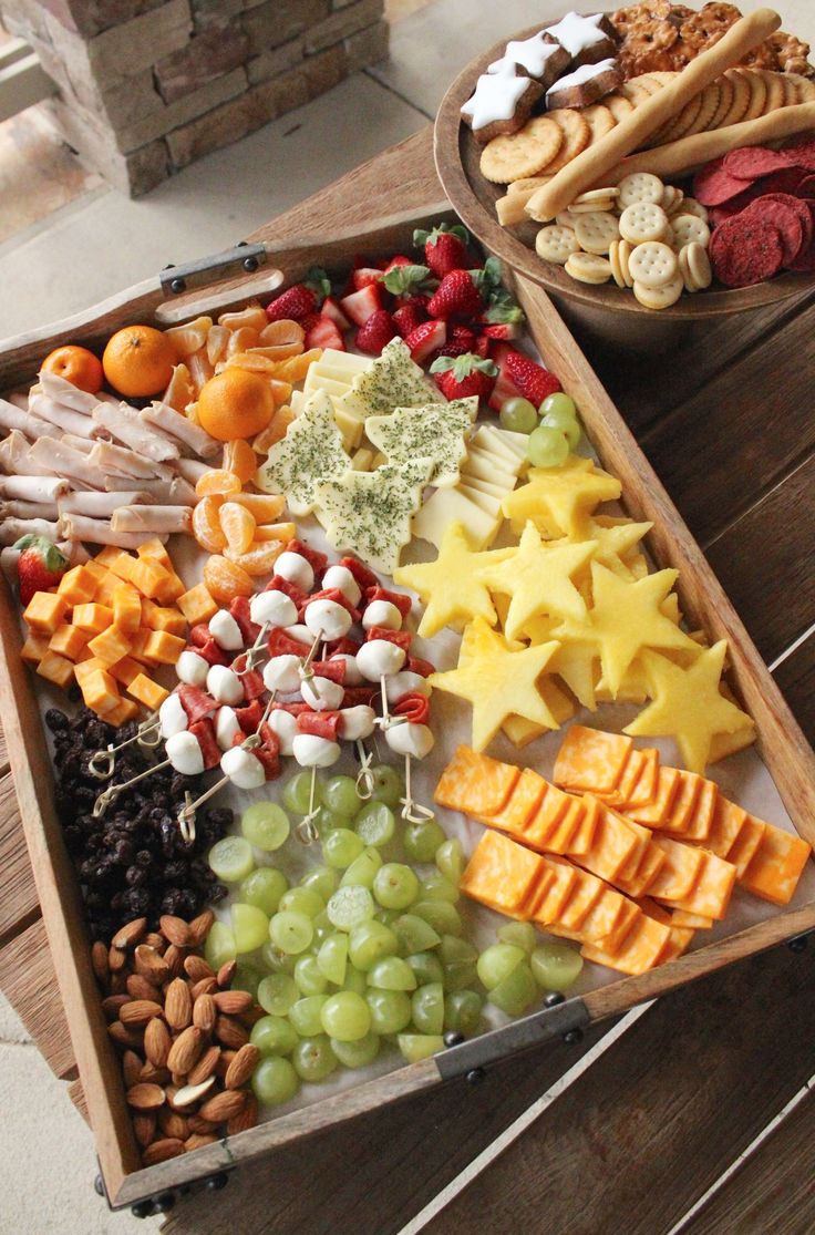 a wooden tray filled with different types of snacks