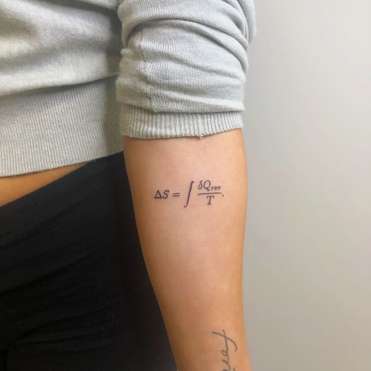 a woman with a tattoo on her arm that says as if it were written in cursive writing