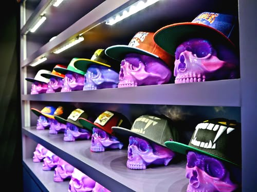 the shelves are filled with colorful hats and skull heads on them, as well as skulls