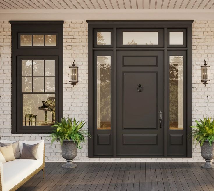 a front door with two planters on either side and a couch in the foreground