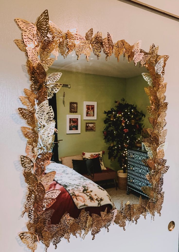 there is a mirror that has gold butterflies on it