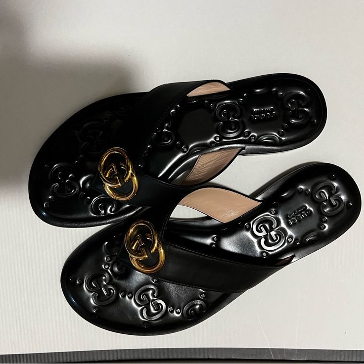 Beautiful Decoration And Can Be Worn In Any Occasion! Excellent Condition, Almost Never Worn! Gucci Black Sandals With Single Toe Strap, Gucci Designer Sandals With Single Toe Strap, Gucci Luxury Sandals With Branded Insole, Designer Gucci Sandals With Single Toe Strap, Gucci Leather Flat Sandals, Gucci Leather Sandals Flat Heel, Designer Slip-on Sandals With Branded Insole, Classic Gucci Leather Sandals, Gucci Flat Sandals With Leather Sole