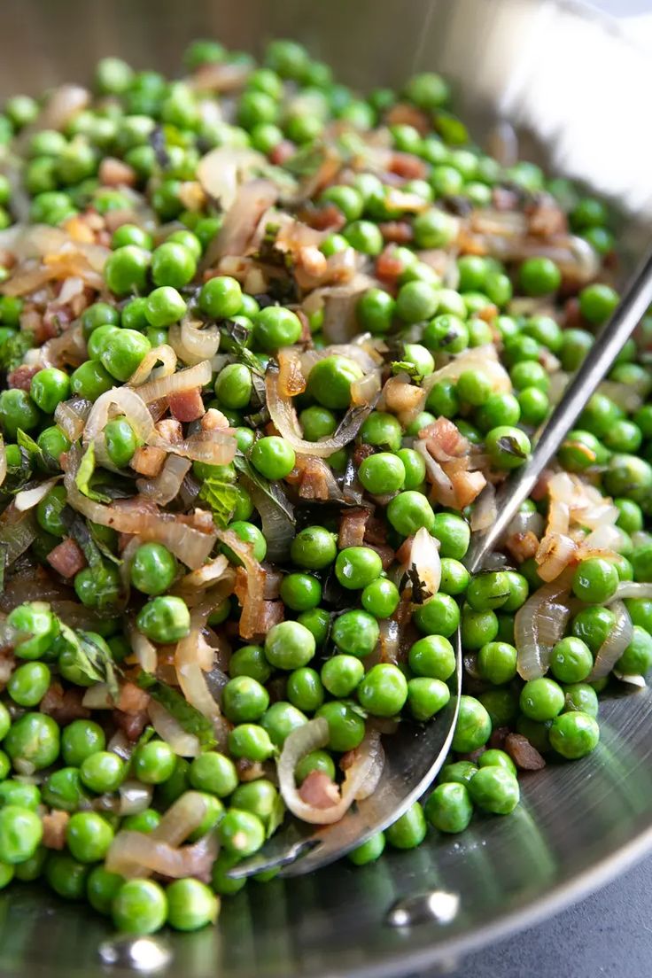 peas and onions in a bowl with a spoon